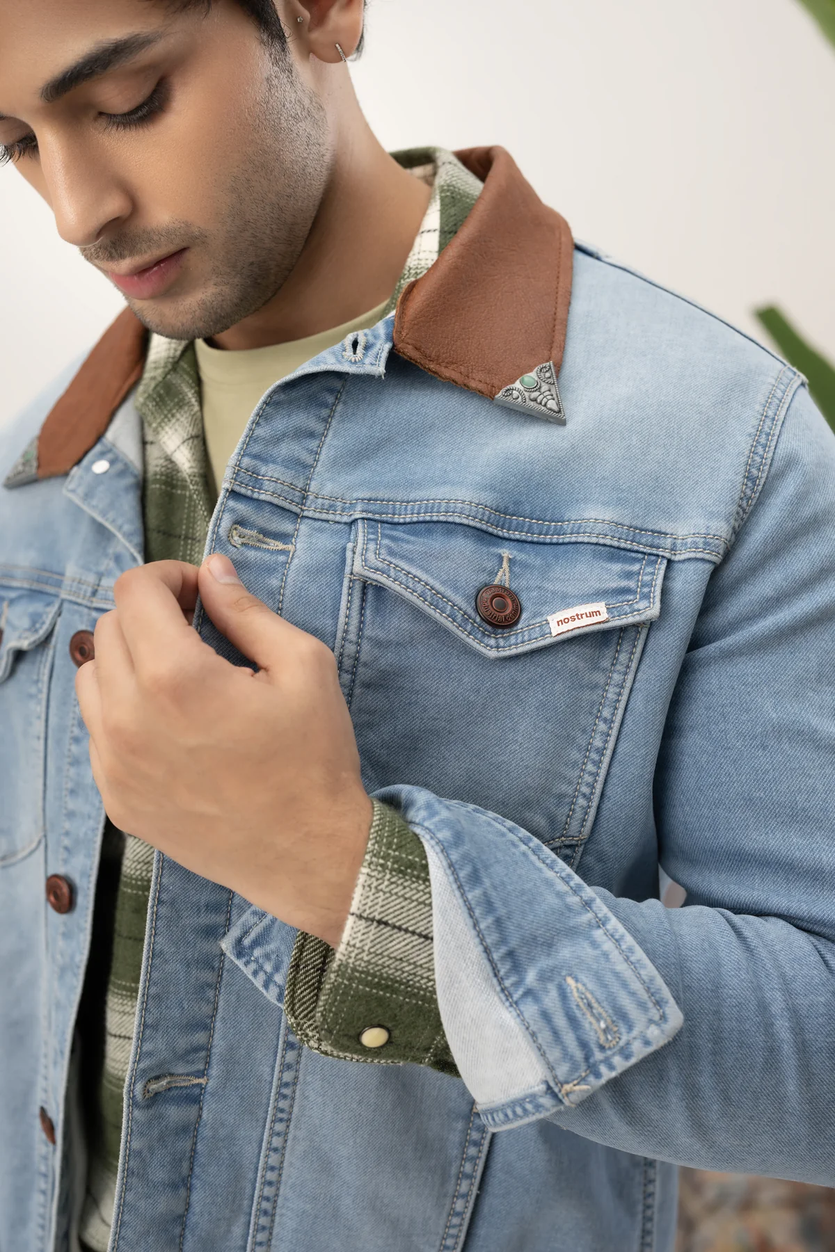 Close detail of a light blue denim jacket