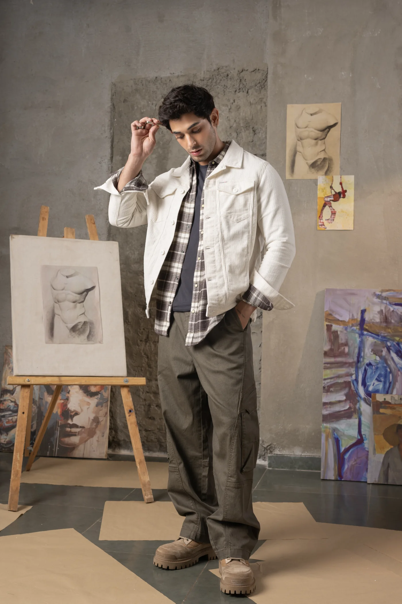 White overshirt layered over a dark checked shirt