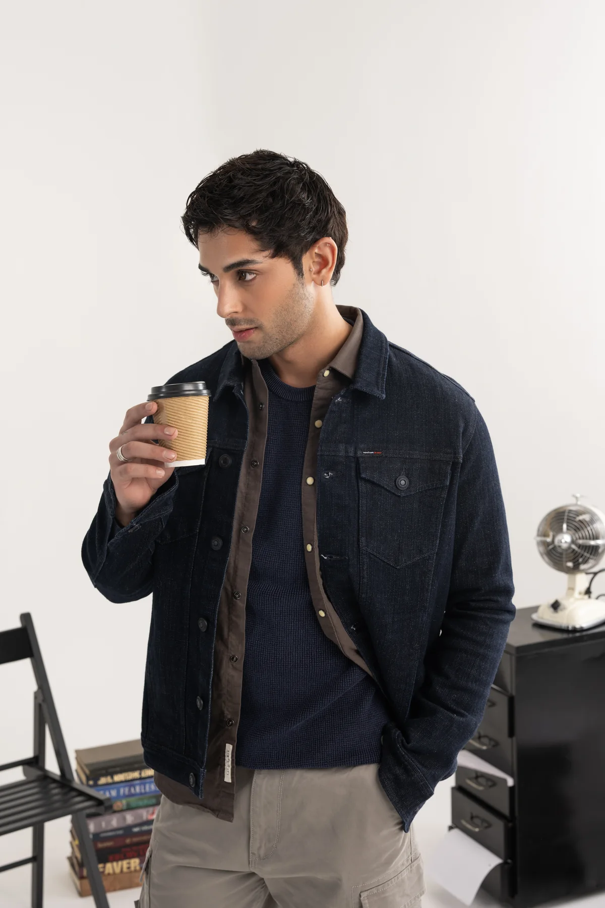 Detail of the indigo jacket and plaid shirt